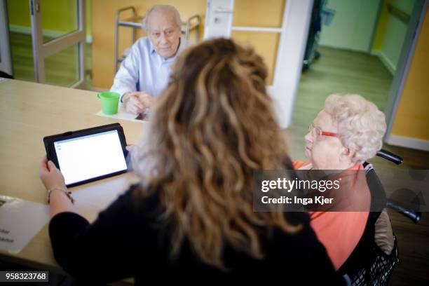 Carer in conversation with residents of a nursing home on April 27, 2018 in Berlin, Germany.