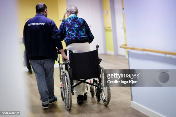 Physiotherapist helps an elderly woman to use a rollator on April 27, 2018 in Berlin, Germany.