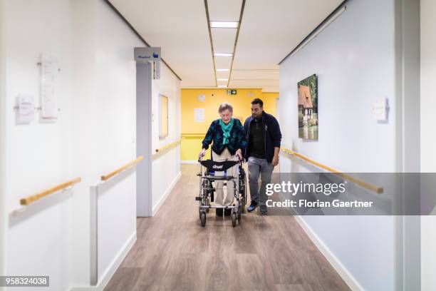 Physiotherapist helps an elderly woman to use a rollator on April 27, 2018 in Berlin, Germany.