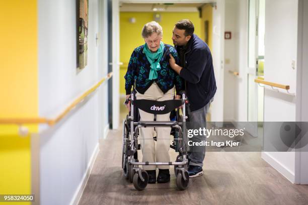 Physiotherapist helps an elderly woman to use a rollator on April 27, 2018 in Berlin, Germany.