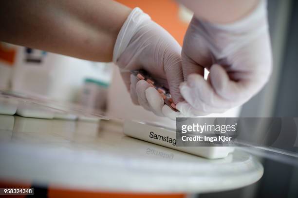 Nurse sorts drugs into tablet dispensers on April 27, 2018 in Berlin, Germany.