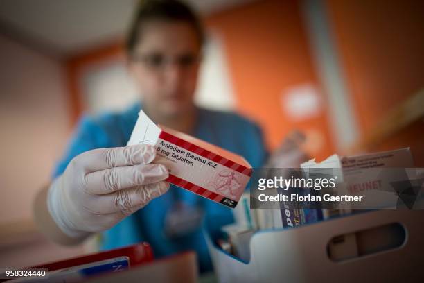 Caregiver takes medicines out of a box on April 27, 2018 in Berlin, Germany.