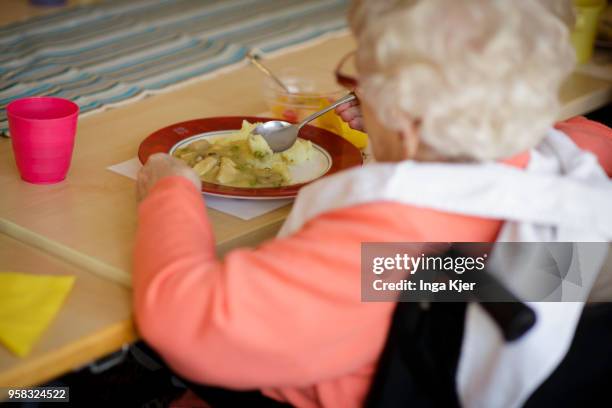 An old woman in a wheelchair having lunch in a nursing home on April 27, 2018 in Berlin, Germany.