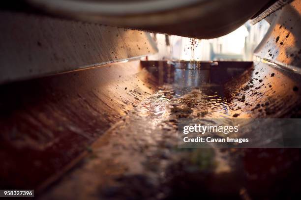 close-up of grape juice falling in machinery - raw materials metals stock pictures, royalty-free photos & images