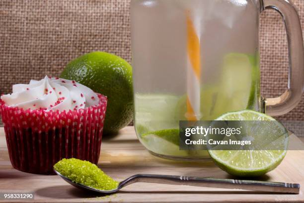 close-up of cup cake with lime juice on table - lime juice stock pictures, royalty-free photos & images