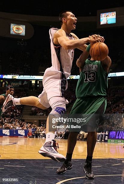 Yi Jianlian of the New Jersey Nets is fouled by Shelden Williams of The Boston Celtics during their game on January 13th, 2010 at The Izod Center in...