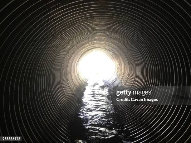 interior of sewage tunnel - マンホール ストックフォトと画像