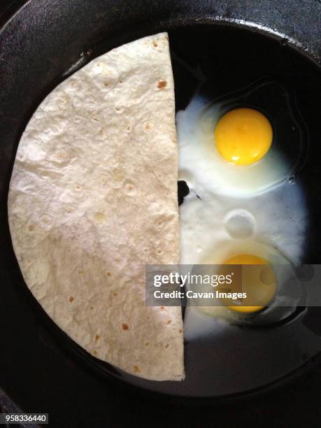 overhead view of flatbread and fried eggs in pan - smiley face stock pictures, royalty-free photos & images
