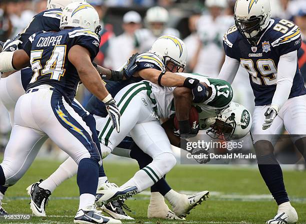 Wide receiver Braylon Edwards of the New York Jets is tackled after making a catch against the San Diego Chargers during the second quarter of the...