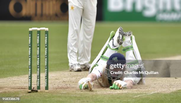 Niall O'Brien of Ireland dives to avoid being run out during the fourth day of the international test cricket match between Ireland and Pakistan on...