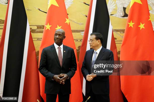 China's Premier Li Keqiang speaks to Trinidad and Tobago Prime Minister Keith Rowley during a signing ceremony at the Great Hall of the People on May...