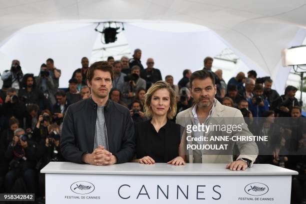 French actor Pierre Deladonchamps, French actress Karin Viard and French actor Clovis Cornillac pose on May 14, 2018 during a photocall for the film...