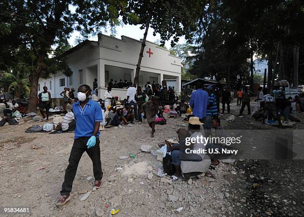 In this handout provided by the U.S. Navy, patients affected by the recent earthquake wait outside the Killick Haitian Coast Guard base clinic to...