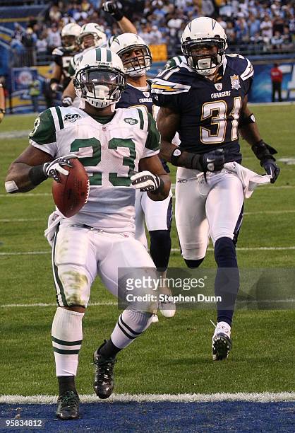 Running back Shonn Greene of the New York Jets scores a touchdown in the fourth quarter in front of cornerback Antonio Cromartie of the San Diego...