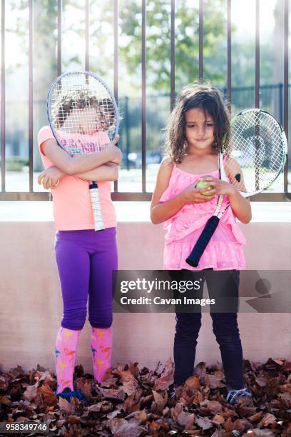 Tennis Racket Against Insaects Girl Holding A Tennis Racket And Two Balls Photos and Premium High Res ...