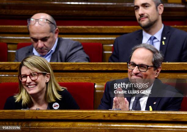 Junts per Catalonia MP and presidential candidate Quim Torra gestures beside Junts per Catalonia MP Elsa Artadi during a vote session to elect a new...