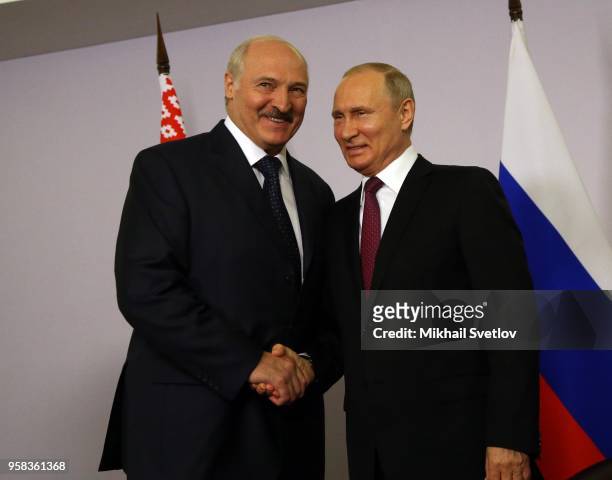 Russian President Vladimir Putin shakes hands with Belarussian President Alexander Lukashenko during their bilateral meeting prior to the Eurasian...