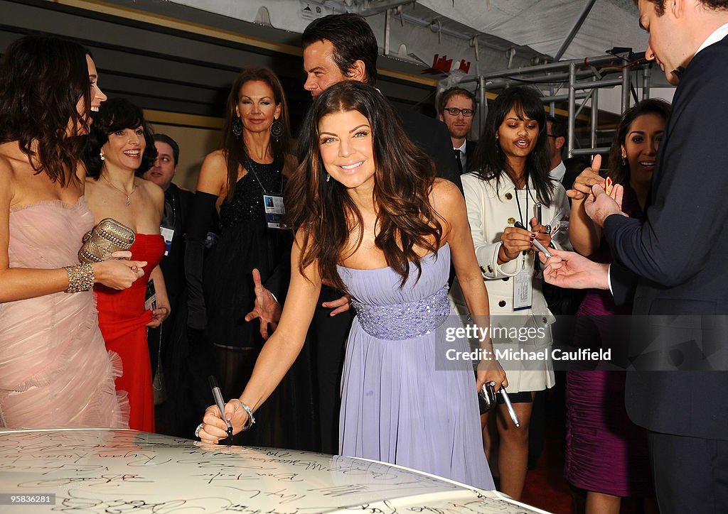 Celebrities Sign Charity Car At 67th Annual Golden Globe Awards