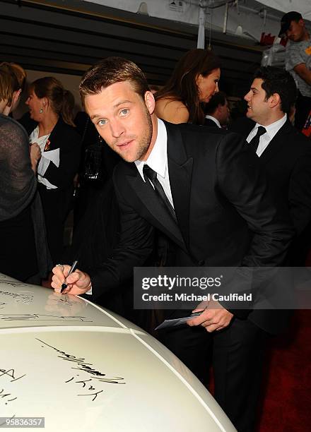 Actor Jesse Spencer signs the Chrysler 300 Eco Style car for Stars for a Cause during the 67th annual Golden Globe Awards held at The Beverly Hilton...