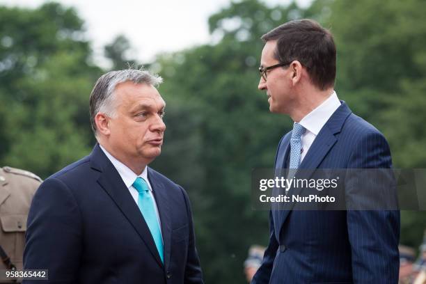 Polish Prime Minister Mateusz Morawiecki welcomes Hungarian Prime Minister Viktor Orban in front of the Lazienki Palace in Warsaw, Poland on 14 May...