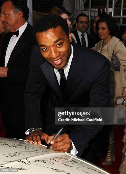 Actor Chiwetel Ejiofor signs the Chrysler 300 Eco Style car for Stars for a Cause during the 67th annual Golden Globe Awards held at The Beverly...