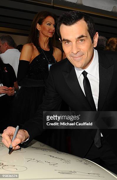 Actor Ty Burrell signs the Chrysler 300 Eco Style car for Stars for a Cause during the 67th annual Golden Globe Awards held at The Beverly Hilton...