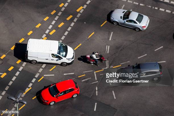Motorcyclist and four cars are pictured on crossroads on May 09, 2018 in Berlin, Germany.