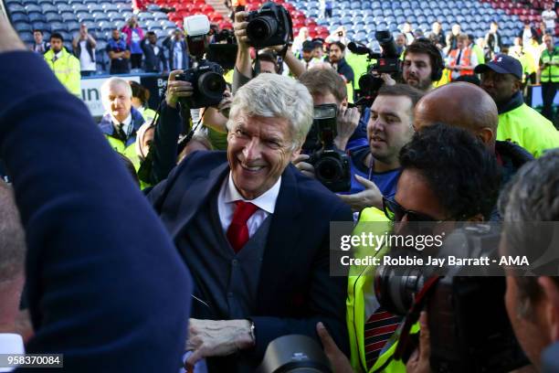 Arsene Wenger head coach / manager of Arsenal engages with the fans of Arsenal at full time after he comes back out during the Premier League match...