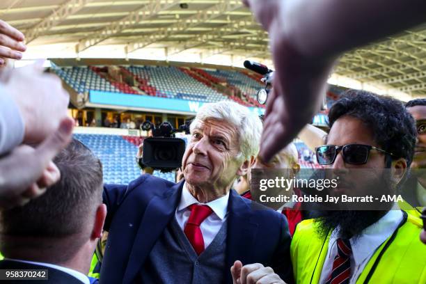 Arsene Wenger head coach / manager of Arsenal engages with the fans of Arsenal at full time after he comes back out during the Premier League match...