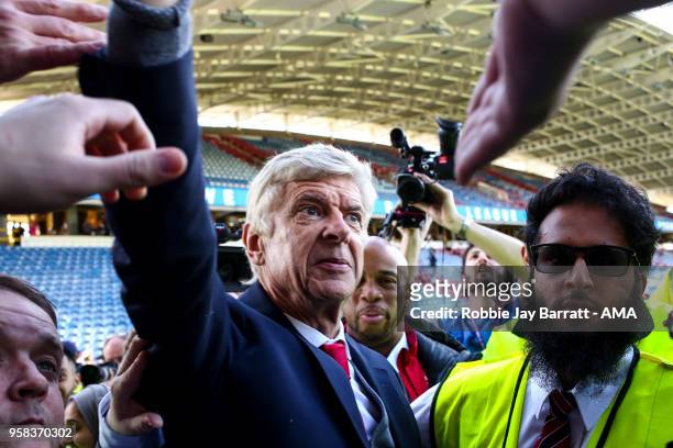 Arsene Wenger head coach / manager of Arsenal engages with the fans of Arsenal at full time after he comes back out during the Premier League match...