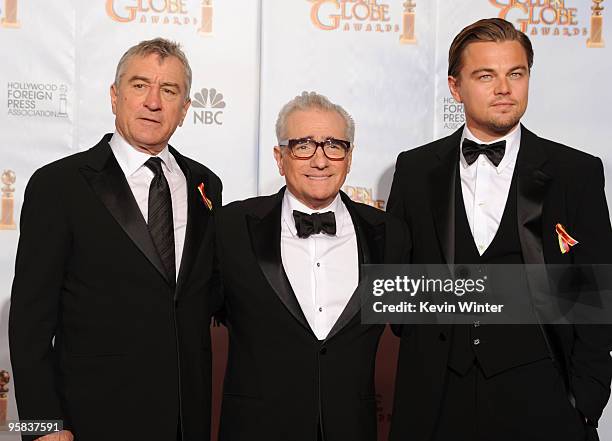 Director Martin Scorsese, recipient of the Cecil B. DeMille Award poses with actors Robert De Niro and Leonardo DiCaprio in the press room after...