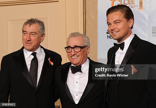 Director Martin Scorsese, recipient of the Cecil B. DeMille Award poses with actors Robert De Niro and Leonardo DiCaprio in the press room after...