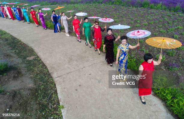 Women dressed in cheongsams perform at a lavender manor to celebrate the Mother's Day on May 13, 2018 in Taizhou, Jiangsu Province of China.