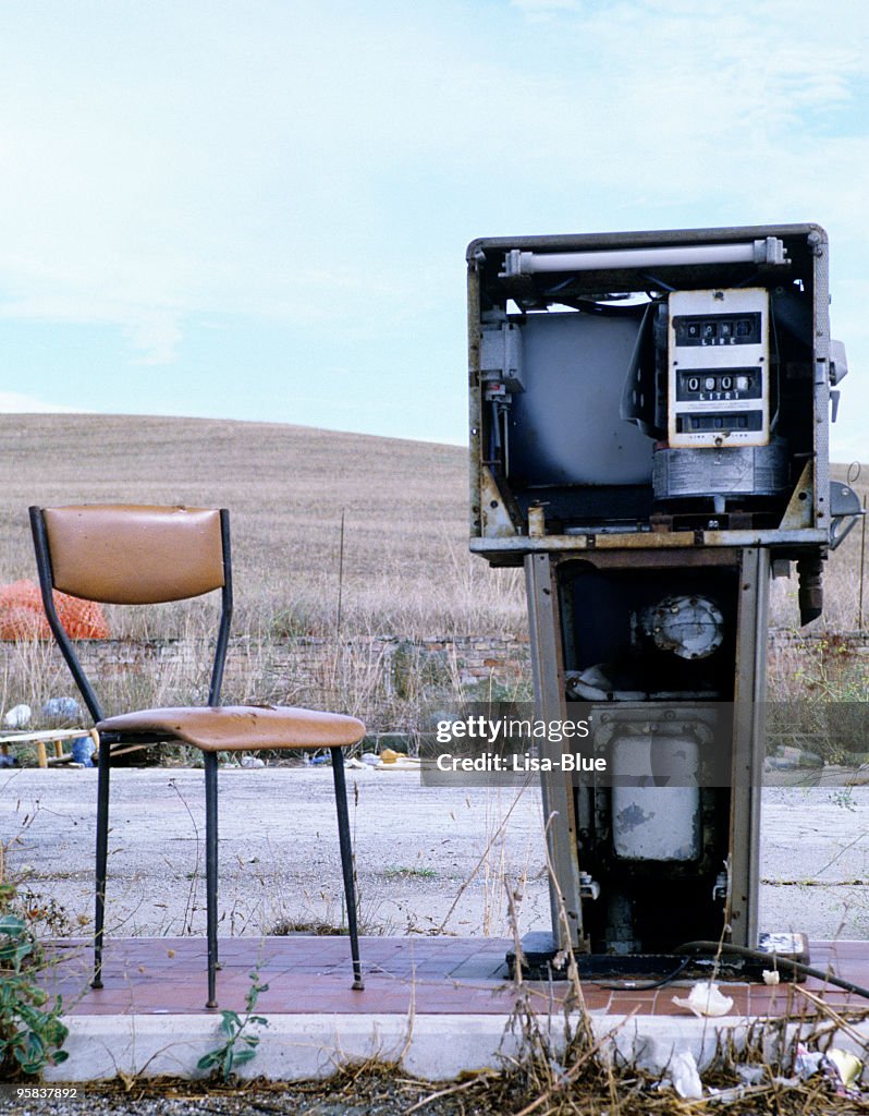 Abandoned Gas Station and Vintage Chair.Rural Scene