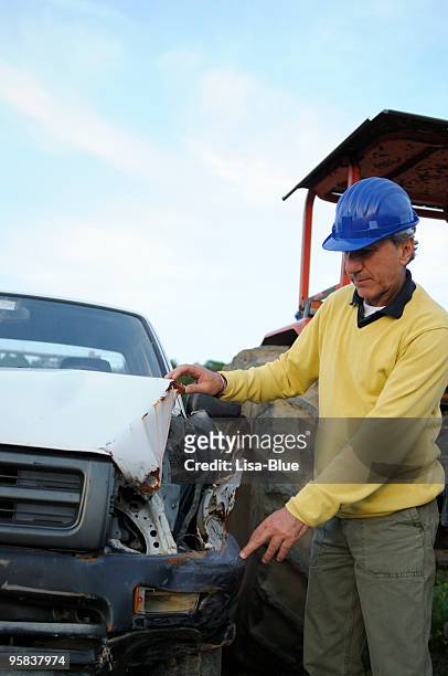 insurance agent or mechanic examining a crushed car - car insurance agent stock pictures, royalty-free photos & images