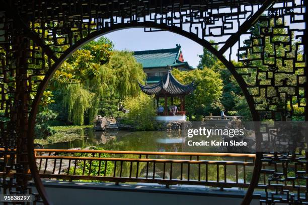 view through screen in a classical chinese garden, - classical chinese garden fotografías e imágenes de stock