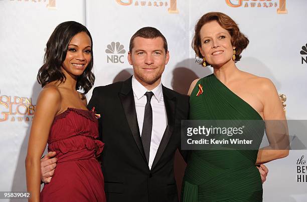Actress Zoe Saldana, actor Sam Worthington and actress Sigourney Weaver, winners of Best Motion Picture, Drama award for "Avatar" pose in the press...