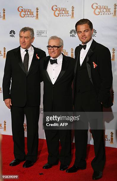 Oscar-winning director Martin Scorsese stands with US actors Leondardo DiCaprio and Robert De Niro , who presented Scorsese the Golden Globes Cecil...