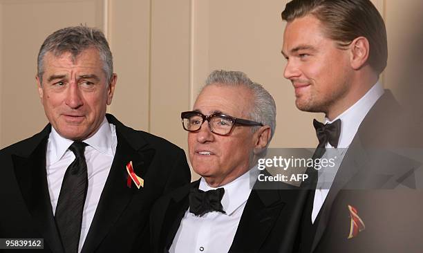 Oscar-winning director Martin Scorsese stands with US actors Leondardo DiCaprio and Robert De Niro , who presented Scorsese the Golden Globes Cecil...