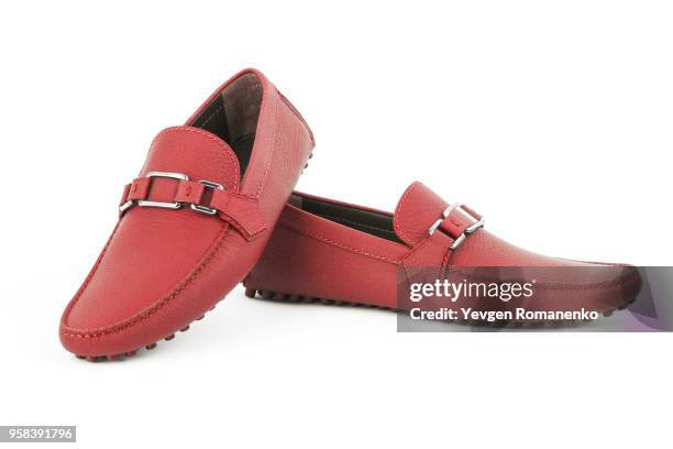 pair of red leather loafers isolated on white background - red shoe stockfoto's en -beelden