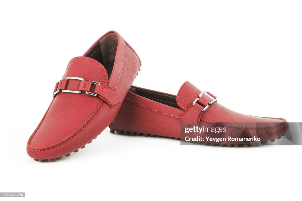 Pair of red leather loafers isolated on white background