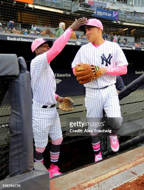 Ronald Torreyes and Didi Gregorius of the New York Yankees leave the dugout ahead of a game against the Oakland Athletics at Yankee Stadium on...