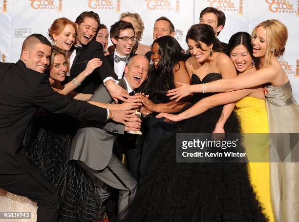 Co-creator/writer Ryan Murphy poses in the press room with the cast of "Glee" with the award for Best Television Series Musical or Comedy for "Glee"...