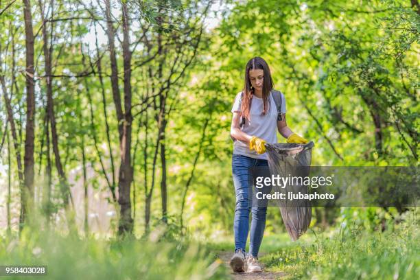 young girl participates in community cleanup - people picking up trash stock pictures, royalty-free photos & images