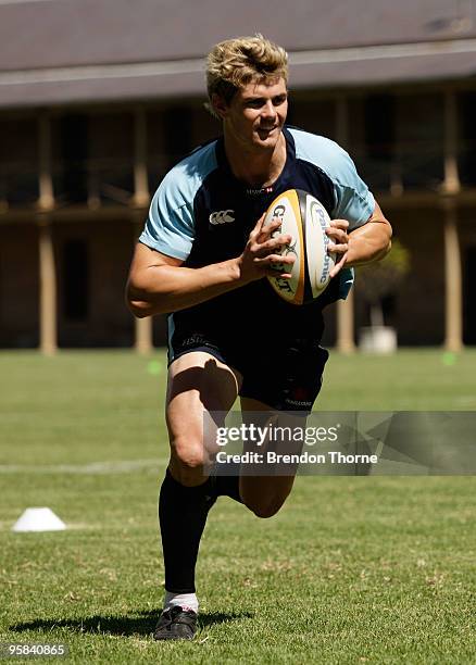 Berrick Barnes runs with the ball during a New South Wales Waratahs Super 14 training session at Victoria Barracks on January 18, 2010 in Sydney,...