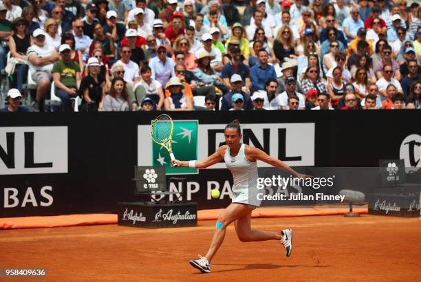 Spectators watch as Roberta Vinci of Italy plays a forehand during the Women's singles first round match against Aleksandra Krunic of Serbia on day...