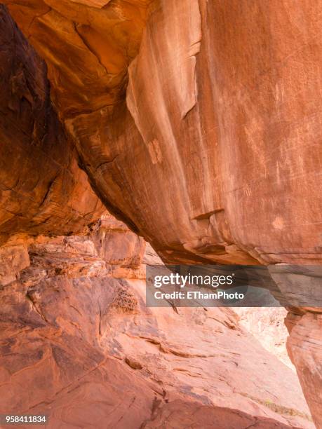 prehistoric petroglyphs (rock carvings) at the valley of fire, nv - rock overhang stock pictures, royalty-free photos & images