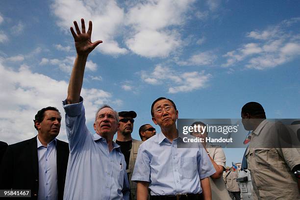 In this handout image provided by the United Nations Stabilization Mission in Haiti , UN Secratary General Ban Ki-moon and Acting SRSG, Edmond Mullet...