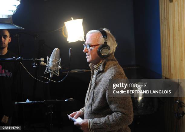 French singer Charles Aznavour is pictured while recording, with a dozen of French rappers and pop stars, a music video to raise funds for...