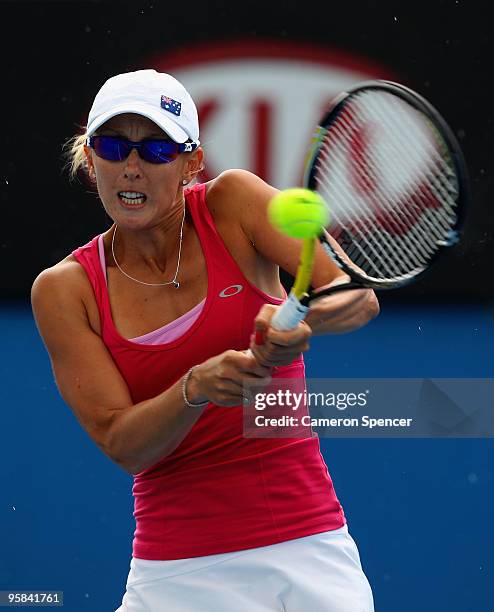 Anastasia Rodionova of Australia plays a backhand in her first round match against Svetlana Kuznetsova of Russia during day one of the 2010...